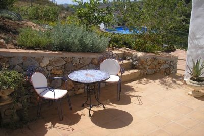 Back terrace surrounded by garden area.