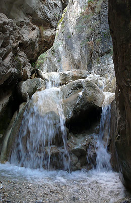 A cascade of water. A cascade tumbles down a steep-sided gorge on the Higuern river.