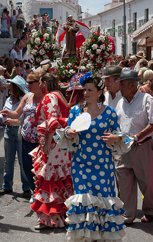 Women in traditional flamenco style dress for a local feria.