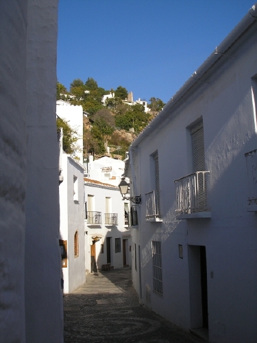 Calle Real winding through the village. A section of the pretty but narrow main street, calle Real, as it winds its way through the village.