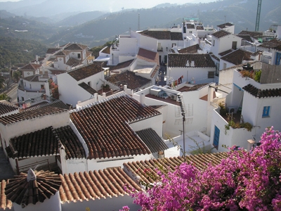 View over the red clay tile rooftops. A misty and smokey view over the red clay tile rooftops of Frigiliana and down through the valley.