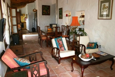 Yet another perspective of the sitting and dining rooms with kitchen in the background.